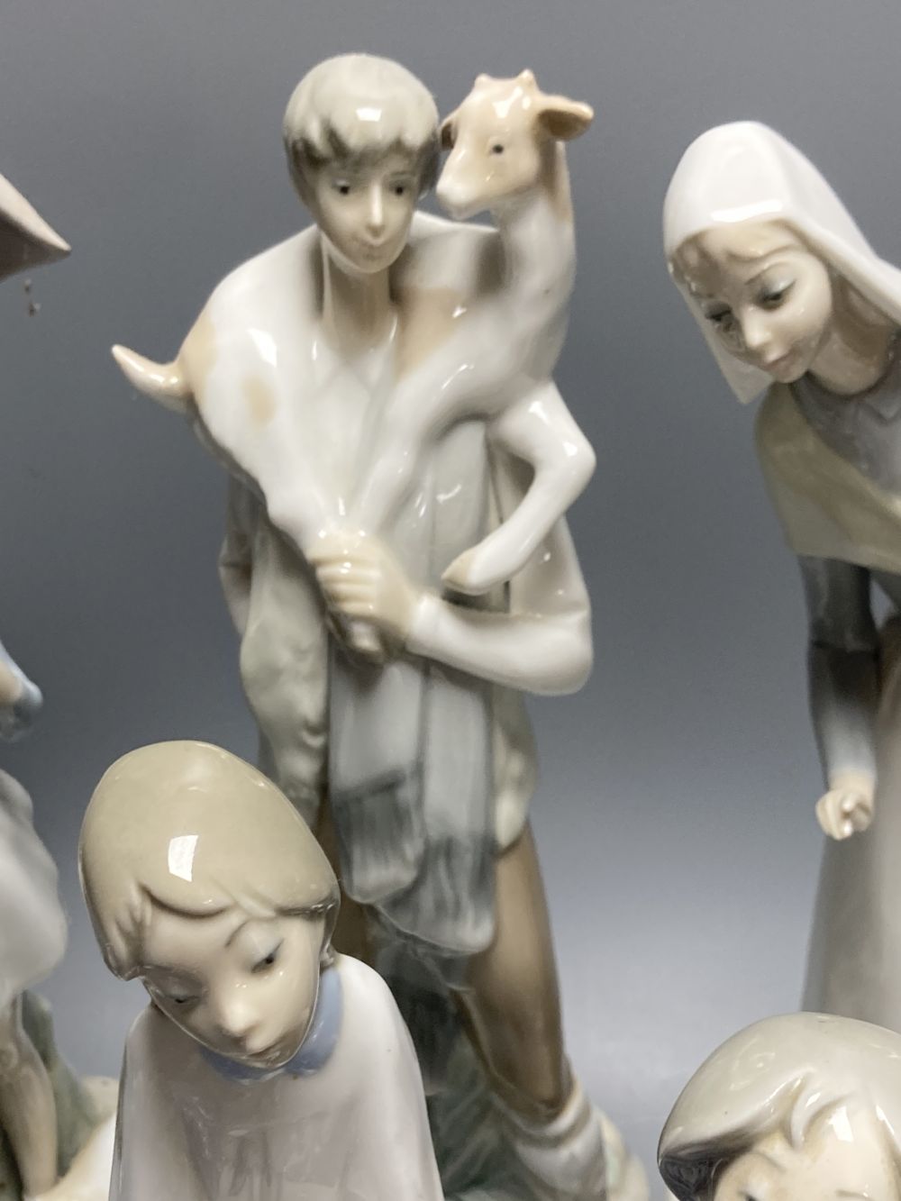 A collection of Lladro and Goebel porcelain figures and other items